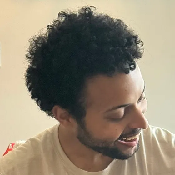 Christopher Smothers laughing, looking down